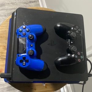 Black ps4 with a blue and black controller